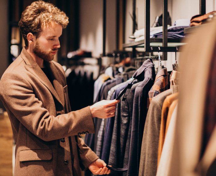 young-handsome-man-choosing-clothes-shop